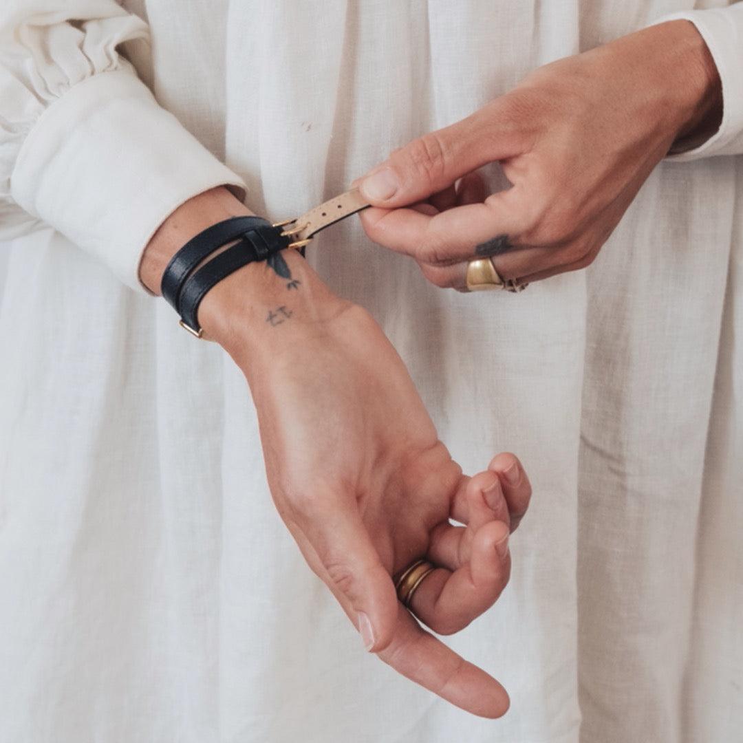 woman wearing black double leather strap kimsey watch
