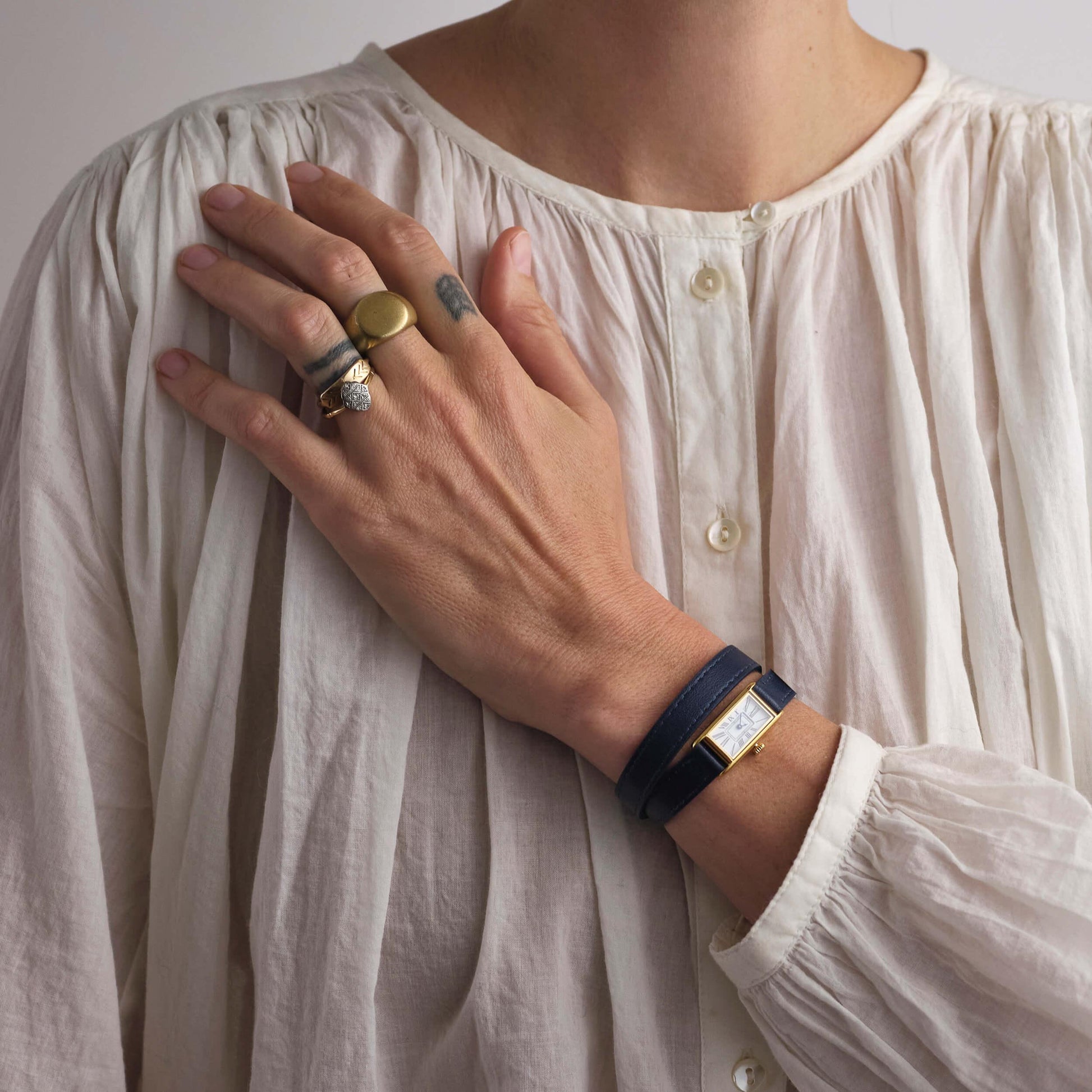 Woman wearing white shirt and navy Kimsey Watch in Brown Leather “Double Wrap” Strap and gold hardware